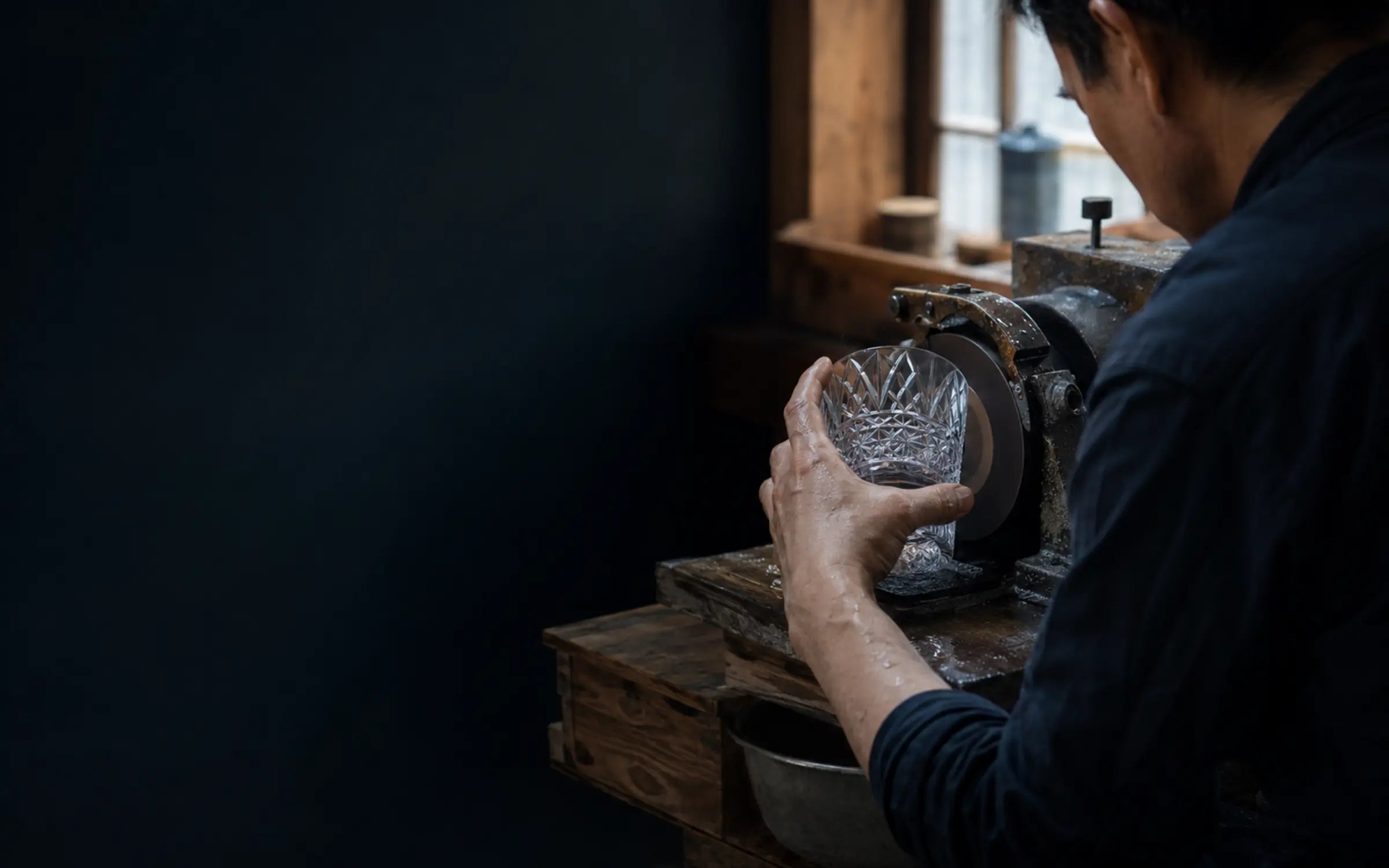 An artisan carefully shaping a Japanese craft object.